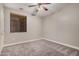 Bedroom with neutral carpeting, ceiling fan and a window with wood blinds at 2939 E Huber St, Mesa, AZ 85213