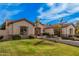 Landscaped front yard leading to an elegant home with stone accents, lawn and mature trees at 2939 E Huber St, Mesa, AZ 85213