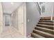 Inviting hallway with tile flooring leading to carpeted stairs with decorative iron railing at 2939 E Huber St, Mesa, AZ 85213