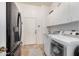 Functional laundry room with stainless steel appliances and ample storage at 2939 E Huber St, Mesa, AZ 85213