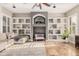 Open-concept living room with built-in shelves, a ceiling fan, and neutral tones at 2939 E Huber St, Mesa, AZ 85213