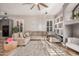 Cozy living room with a large sectional sofa, ceiling fan, and built-in shelves at 2939 E Huber St, Mesa, AZ 85213