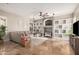 Spacious living room with a ceiling fan, built-in shelves, and natural light from the window at 2939 E Huber St, Mesa, AZ 85213