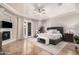 Elegant main bedroom features a fireplace, ceiling fan, and access to the outdoors at 2939 E Huber St, Mesa, AZ 85213