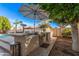 Covered outdoor kitchen with built-in grill and counter, perfect for backyard entertaining at 2939 E Huber St, Mesa, AZ 85213