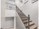 Elegant staircase with decorative iron railing, carpeted steps, and neutral color scheme at 2939 E Huber St, Mesa, AZ 85213