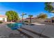 Beautiful pool with a tanning shelf and lush landscaping, perfect for backyard relaxation at 2939 E Huber St, Mesa, AZ 85213