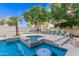 Gorgeous outdoor pool with a spa, built in seating, bar and fire pit for relaxation and entertainment at 2939 E Huber St, Mesa, AZ 85213