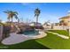 Inviting backyard oasis featuring a sparkling pool, waterfall, and lush landscaping at 2942 S Sierra Hts, Mesa, AZ 85212