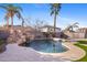 Relaxing pool area with a waterfall, lounge chairs, and palm trees at 2942 S Sierra Hts, Mesa, AZ 85212