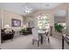 Spacious dining area with a glass-top table, chairs and adjacent seating area at 29590 N Balmoral Pl, San Tan Valley, AZ 85143