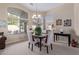 Elegant dining room featuring a dark wood table and four chairs at 29590 N Balmoral Pl, San Tan Valley, AZ 85143