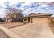 House exterior with driveway, landscaping and two-car garage at 29590 N Balmoral Pl, San Tan Valley, AZ 85143