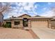 Single story home with a two-car garage and desert landscaping at 29590 N Balmoral Pl, San Tan Valley, AZ 85143