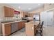 Modern kitchen with light wood cabinets, stainless steel appliances and island at 29590 N Balmoral Pl, San Tan Valley, AZ 85143