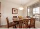 Cozy dining area with a wood table and chairs near a window at 30130 N Jillian Dr, San Tan Valley, AZ 85143