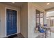 Inviting entryway with a blue front door and small patio seating at 30130 N Jillian Dr, San Tan Valley, AZ 85143