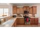 Well-equipped kitchen with light wood cabinets and a corner sink at 30130 N Jillian Dr, San Tan Valley, AZ 85143