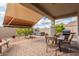 Covered patio with retractable awning, seating, and hot tub at 30130 N Jillian Dr, San Tan Valley, AZ 85143