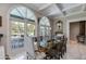 Bright dining room with arched windows, a large table, and access to a patio at 3047 E Marshall Ave, Phoenix, AZ 85016