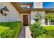 Inviting entryway with a charming wood door and lush greenery at 3047 E Marshall Ave, Phoenix, AZ 85016