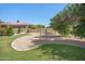 Landscaped backyard with a playset and mature trees at 3447 E Kenwood St, Mesa, AZ 85213