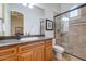 Bathroom with granite countertop, wood cabinets and shower at 3447 E Kenwood St, Mesa, AZ 85213