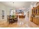 Open dining area with a round table and chairs, near kitchen and living area at 3447 E Kenwood St, Mesa, AZ 85213