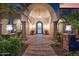 Grand entryway with arched columns and a beautiful, ornate door at 3447 E Kenwood St, Mesa, AZ 85213