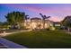 Beautiful home exterior at dusk with lush landscaping at 3447 E Kenwood St, Mesa, AZ 85213