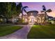 Elegant Spanish-style home with palm trees and a brick pathway at 3447 E Kenwood St, Mesa, AZ 85213