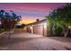 Three-car garage with a paved driveway and gated entry at 3447 E Kenwood St, Mesa, AZ 85213