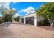 Three-car garage with dark gray doors and paver driveway at 3447 E Kenwood St, Mesa, AZ 85213