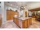 Large kitchen with granite island, custom cabinetry, and stainless steel appliances at 3447 E Kenwood St, Mesa, AZ 85213