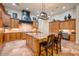 Spacious kitchen with light wood cabinetry, granite island, and high-end appliances at 3447 E Kenwood St, Mesa, AZ 85213