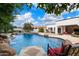 Relaxing pool area with a waterfall feature and comfortable seating at 3447 E Kenwood St, Mesa, AZ 85213