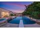 Inviting pool and spa with a diving board and rock waterfall feature at 3447 E Kenwood St, Mesa, AZ 85213