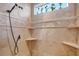 Walk-in shower with multiple shower heads and built-in shelving at 3447 E Kenwood St, Mesa, AZ 85213