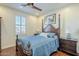 Guest bedroom with a post bed and hardwood floors at 36168 N Stoneware Dr, Queen Creek, AZ 85140