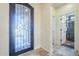 Bright and spacious entryway with an ornate door and a view of the bathroom at 36168 N Stoneware Dr, Queen Creek, AZ 85140