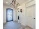 Inviting entryway with a statement chandelier and elegant door at 36168 N Stoneware Dr, Queen Creek, AZ 85140