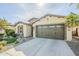 Beautiful desert home with a large driveway and lush landscaping at 36168 N Stoneware Dr, Queen Creek, AZ 85140