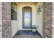 Elegant front door with decorative ironwork and a welcoming entryway at 36168 N Stoneware Dr, Queen Creek, AZ 85140