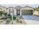 Single-story home with front yard and two-car garage at 36168 N Stoneware Dr, Queen Creek, AZ 85140