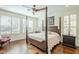 Bright main bedroom with a post bed and hardwood floors at 36168 N Stoneware Dr, Queen Creek, AZ 85140