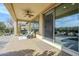 Covered patio with seating area, ceiling fan, and sliding glass doors at 36168 N Stoneware Dr, Queen Creek, AZ 85140