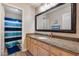 Bathroom with granite countertops, large mirror, and striped shower curtain at 3639 E San Pedro Ave, Gilbert, AZ 85234