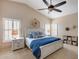 Primary bedroom with king bed, blue bedding, and ensuite bathroom at 3639 E San Pedro Ave, Gilbert, AZ 85234