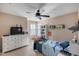 Cozy bedroom with built-in shelving, TV, and ocean-themed bedding at 3639 E San Pedro Ave, Gilbert, AZ 85234