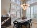 Bright dining room with a large table, chandelier, and plantation shutters at 3639 E San Pedro Ave, Gilbert, AZ 85234